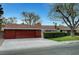 Charming single-story home with a well-manicured lawn and mature landscaping and a red tone at 1801 S 15Th St, Las Vegas, NV 89104