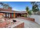 Inviting front patio with brick accents, rock water feature, and lush landscaping for outdoor enjoyment at 1801 S 15Th St, Las Vegas, NV 89104