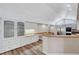 Open kitchen with white cabinetry, granite countertops, stainless steel appliances and wood flooring at 1801 S 15Th St, Las Vegas, NV 89104