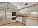 Well-equipped kitchen with stainless steel appliances, including a refrigerator, oven, cooktop, and dishwasher at 1801 S 15Th St, Las Vegas, NV 89104