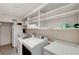 Functional laundry room with washer, dryer, sink, refrigerator, and plenty of shelving for storage at 1801 S 15Th St, Las Vegas, NV 89104