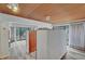 Living room with wood ceiling, sliding glass doors leading to the backyard and built in cabinet at 1801 S 15Th St, Las Vegas, NV 89104