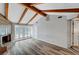 Comfortable living room features exposed wood beams, a fireplace, and French doors leading to the outside at 1801 S 15Th St, Las Vegas, NV 89104