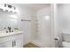 Bright bathroom featuring a shower, vanity, modern fixtures, and a plant for a touch of green at 1891 Brian Rd, Pahrump, NV 89048