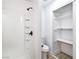 Clean bathroom with a shower, toilet, and a convenient storage closet featuring adjustable shelves at 1891 Brian Rd, Pahrump, NV 89048