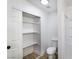 Bright bathroom offering a closet with shelves and a toilet, offering convenient storage solutions at 1891 Brian Rd, Pahrump, NV 89048