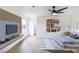 A styled bedroom with wood-look flooring, modern decor, and a large TV at 1891 Brian Rd, Pahrump, NV 89048