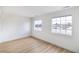 A light-filled bedroom offers modern vinyl floors and two large windows at 1891 Brian Rd, Pahrump, NV 89048