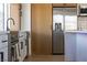 Close-up of kitchen with stainless steel refrigerator and oven, wooden cabinets and modern fixtures at 1891 Brian Rd, Pahrump, NV 89048