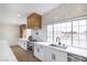 Bright kitchen boasts shaker cabinets, stainless appliances, sleek countertops, and natural light from a large window at 1891 Brian Rd, Pahrump, NV 89048