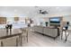 Open-concept living room with kitchen view, modern furniture, and large TV over electric fireplace at 1891 Brian Rd, Pahrump, NV 89048
