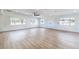 Large open living room featuring wood flooring, recessed lighting, and large windows with natural light at 1891 Brian Rd, Pahrump, NV 89048