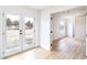 Bright living room featuring wood-look flooring and French doors to the backyard at 1891 Brian Rd, Pahrump, NV 89048