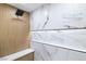 Close-up of a stylish walk-in shower with marble-look tile and modern fixtures at 1891 Brian Rd, Pahrump, NV 89048