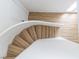 Stylish curved staircase with wood steps, white railing, and wood-look accent wall at 1891 Brian Rd, Pahrump, NV 89048