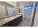 Bathroom features double vanity with granite counters and a bathtub and shower combo at 22 Kaku Ridge Way, Las Vegas, NV 89183