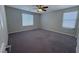 Neutral bedroom features gray carpet, two windows with blinds and gray walls at 22 Kaku Ridge Way, Las Vegas, NV 89183
