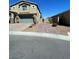 Two story home with a landscaped front yard and an attached two car garage at 22 Kaku Ridge Way, Las Vegas, NV 89183