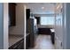Galley kitchen boasts stainless appliances, dark cabinetry, and granite countertops at 22 Kaku Ridge Way, Las Vegas, NV 89183