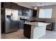 Modern kitchen with stainless appliances, granite countertops, and a kitchen island at 22 Kaku Ridge Way, Las Vegas, NV 89183