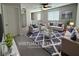 Cozy living room with plush seating, a stylish rug, and plenty of natural light at 22 Kaku Ridge Way, Las Vegas, NV 89183