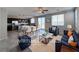 Open-concept living room showcases modern design with a kitchen, dining area, and stylish furnishings at 22 Kaku Ridge Way, Las Vegas, NV 89183