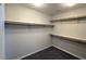 Walk-in closet features ample shelf space, gray walls and plush gray carpet at 22 Kaku Ridge Way, Las Vegas, NV 89183