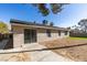 Exterior view of a home with a spacious backyard, featuring artificial turf, desert landscaping, and a concrete patio at 2205 Mccoig Ave, Las Vegas, NV 89119