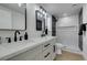 Modern bathroom with double vanity, black accents and shower with black and white tiles at 2205 Mccoig Ave, Las Vegas, NV 89119