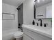 Updated bathroom features modern vanity, black hardware, updated shower with niche, and sleek design at 2205 Mccoig Ave, Las Vegas, NV 89119