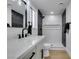 Modern bathroom featuring sleek black fixtures, shower with elegant marble and black tiling, and a bright, updated vanity at 2205 Mccoig Ave, Las Vegas, NV 89119