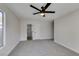 Spacious carpeted bedroom featuring a window and views to the bathroom at 2205 Mccoig Ave, Las Vegas, NV 89119