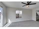 Spacious carpeted bedroom featuring a window and views to the bathroom at 2205 Mccoig Ave, Las Vegas, NV 89119