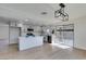 Open kitchen with a large island, stainless steel appliances, and a modern lighting fixture at 2205 Mccoig Ave, Las Vegas, NV 89119