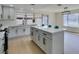 Modern kitchen featuring white cabinets, quartz countertops, island and stainless steel appliances at 2205 Mccoig Ave, Las Vegas, NV 89119