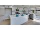 Open kitchen with a large island, stainless steel appliances, and a modern lighting fixture at 2205 Mccoig Ave, Las Vegas, NV 89119