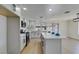 Bright, open kitchen features white cabinets, stainless steel appliances, quartz counters and a view to the backyard at 2205 Mccoig Ave, Las Vegas, NV 89119