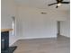 Bright, modern living room featuring a fireplace, ceiling fan, and light-colored flooring at 2205 Mccoig Ave, Las Vegas, NV 89119