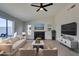 Bright living room features a fireplace, light wood floors, modern furniture, and large sliding glass door at 2205 Mccoig Ave, Las Vegas, NV 89119