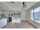 Bright, open living room and kitchen area with sleek countertops and a stylish light fixture at 2205 Mccoig Ave, Las Vegas, NV 89119