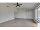 Bright living room with ceiling fan and large windows showcasing the front yard at 2205 Mccoig Ave, Las Vegas, NV 89119