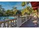 Balcony view overlooking lush landscaping, pool, and palm trees, creating a serene outdoor space at 230 E Flamingo Rd # 115, Las Vegas, NV 89169