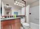 Bathroom features a granite countertop and a shower-over-tub with bright vanity lighting at 230 E Flamingo Rd # 115, Las Vegas, NV 89169