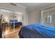 Bedroom with mirror closet doors and hard wood floors at 230 E Flamingo Rd # 115, Las Vegas, NV 89169