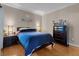 Cozy bedroom with wood floors, decorative mirrors, and dark wood furnishings at 230 E Flamingo Rd # 115, Las Vegas, NV 89169