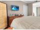 Comfortable bedroom with a mounted TV and a glimpse into the ensuite bathroom at 230 E Flamingo Rd # 115, Las Vegas, NV 89169