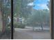 A peaceful courtyard view shows a tree-lined walkway with a glimpse of community buildings at 230 E Flamingo Rd # 115, Las Vegas, NV 89169