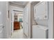 Hallway leading to the bathroom with a stacked washer and dryer unit at 230 E Flamingo Rd # 115, Las Vegas, NV 89169