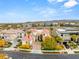 Aerial view of a luxurious home with manicured landscaping, a red tile roof, and stunning mountain views at 2660 Mirabella St, Henderson, NV 89052