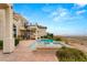 Luxury home backyard features a pool, spa, patio, outdoor staircase, and desert landscape at 2660 Mirabella St, Henderson, NV 89052